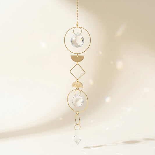 Handmade gold geometric suncatcher with crystal prisms catching sunlight, ideal boho gift for mom.