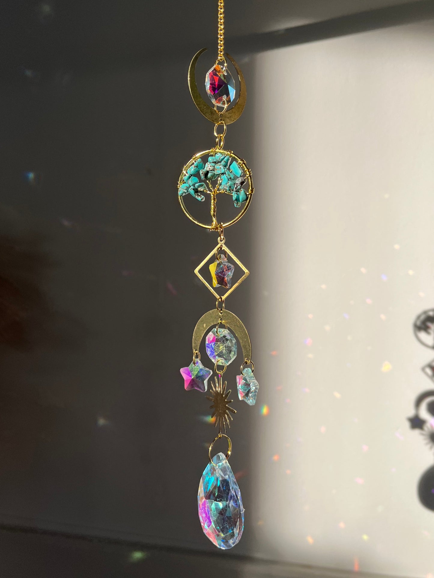 Decorative suncatcher accessory with gemstones on a reflective surface