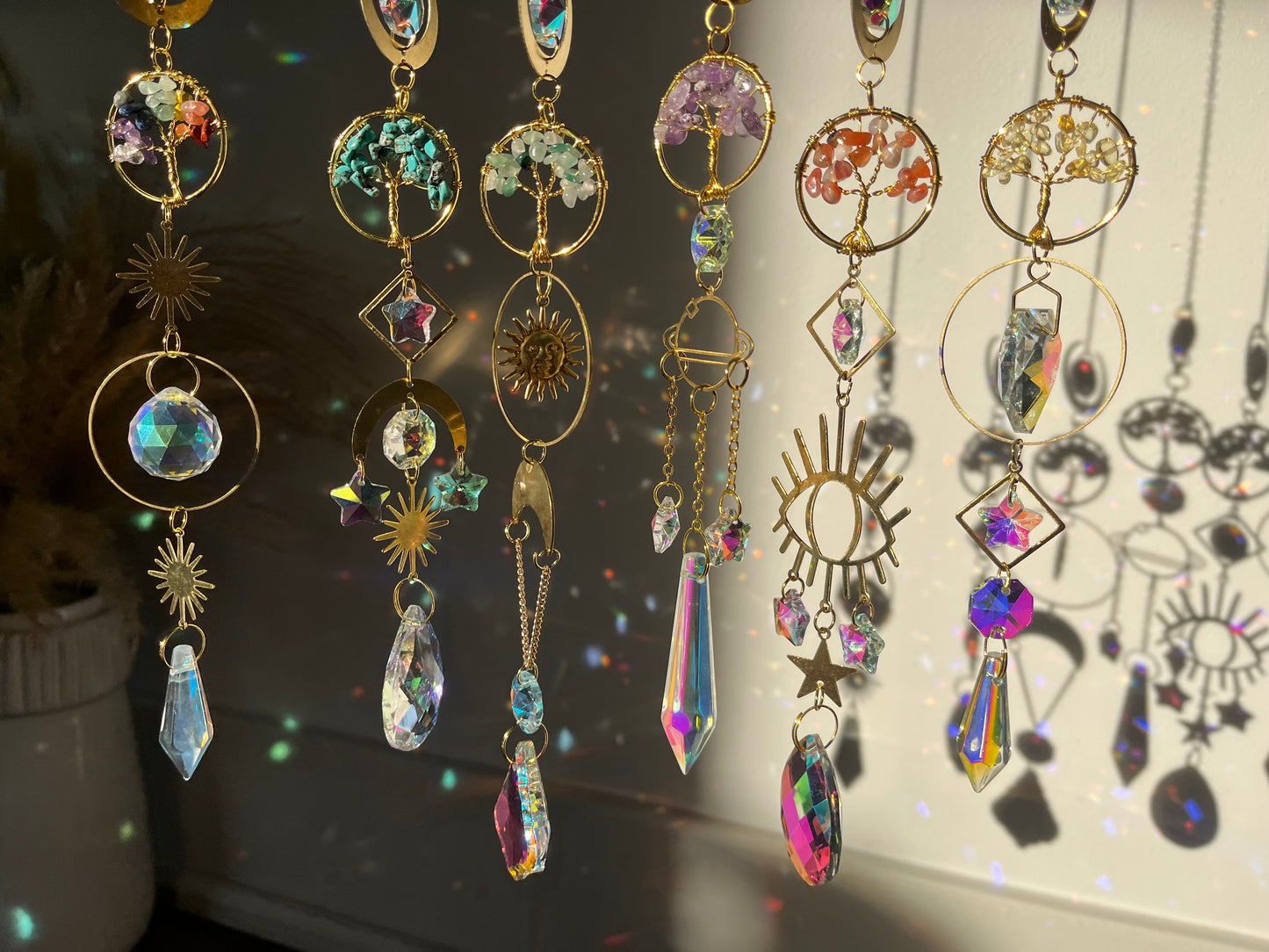 Colorful crystal suncacher hanging against a dark background