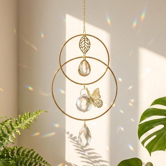 Decorative hanging ornament with crystal elements and gold accents, placed against a light background with plants.