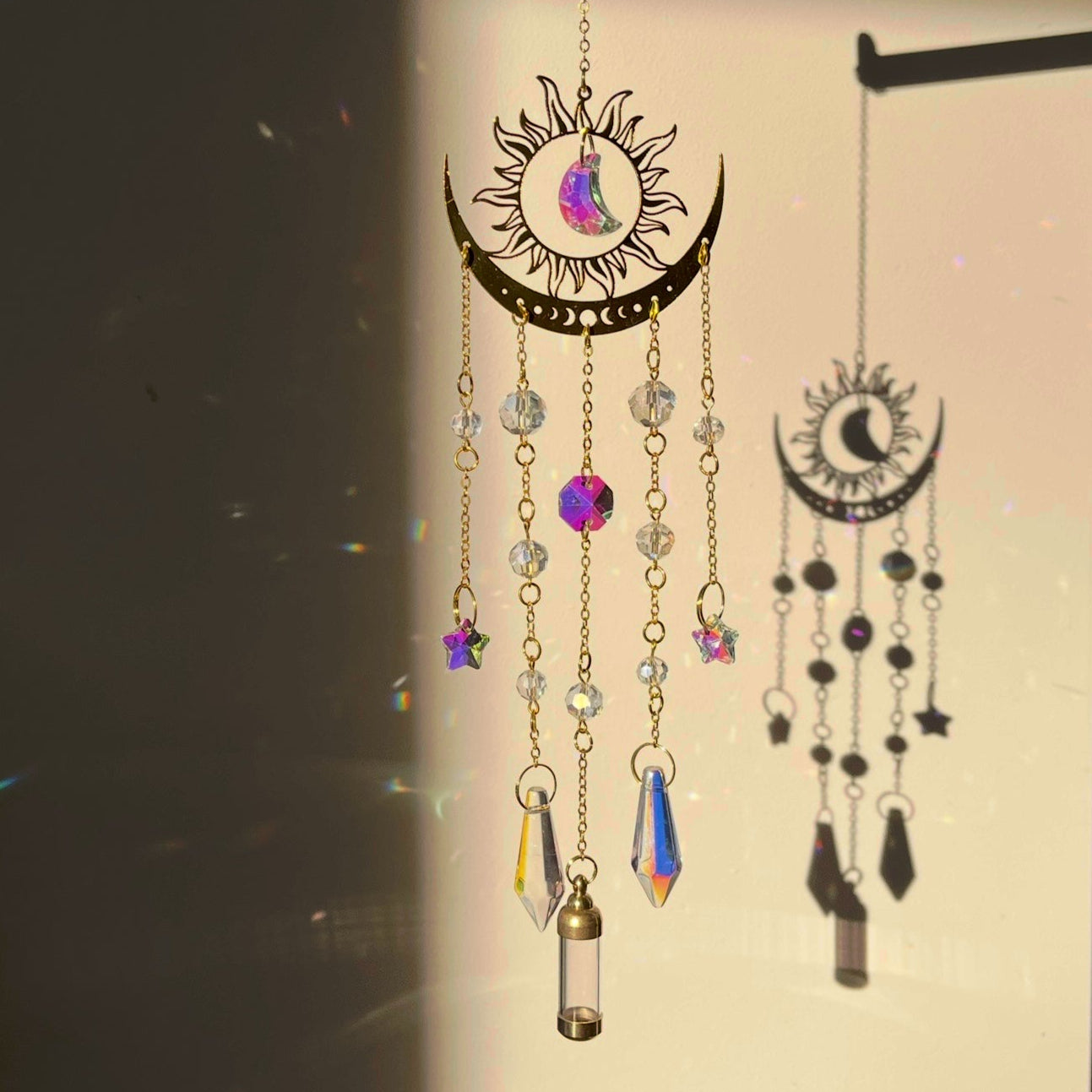 Decorative wall hanging with celestial design on a plain wall.