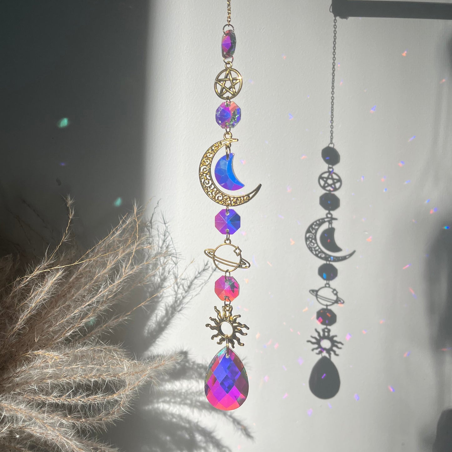 Decorative hanging ornament with celestial design on a dark background