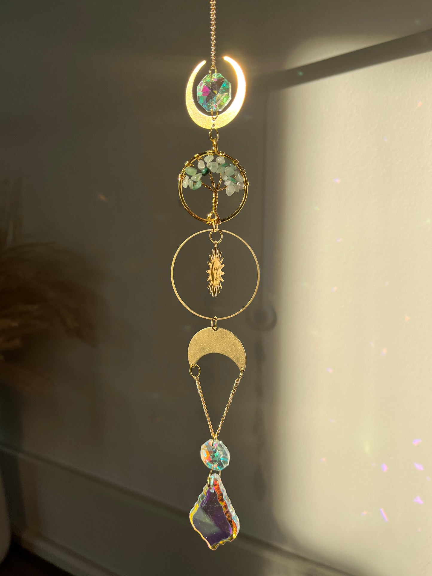 Decorative wall hanging with celestial design on a plain background