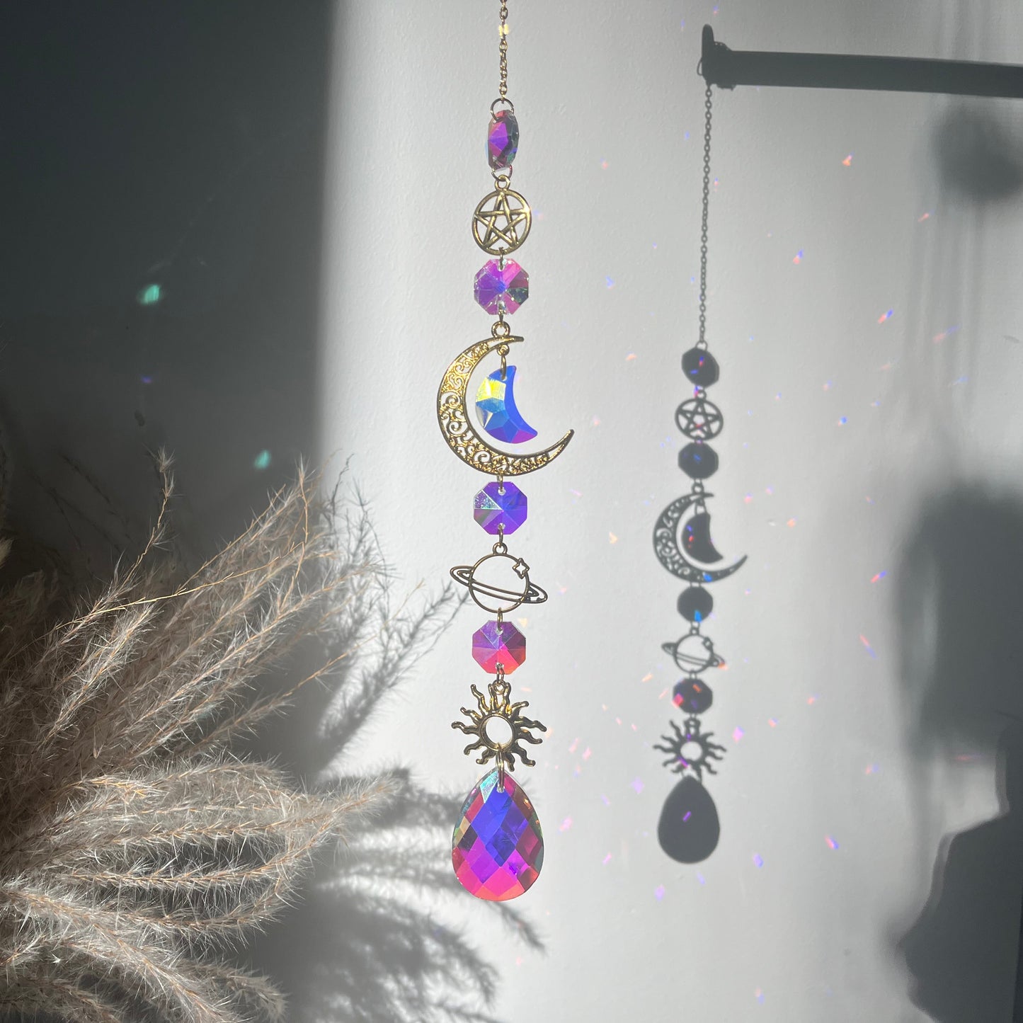 Decorative hanging ornament with celestial design on a dark background