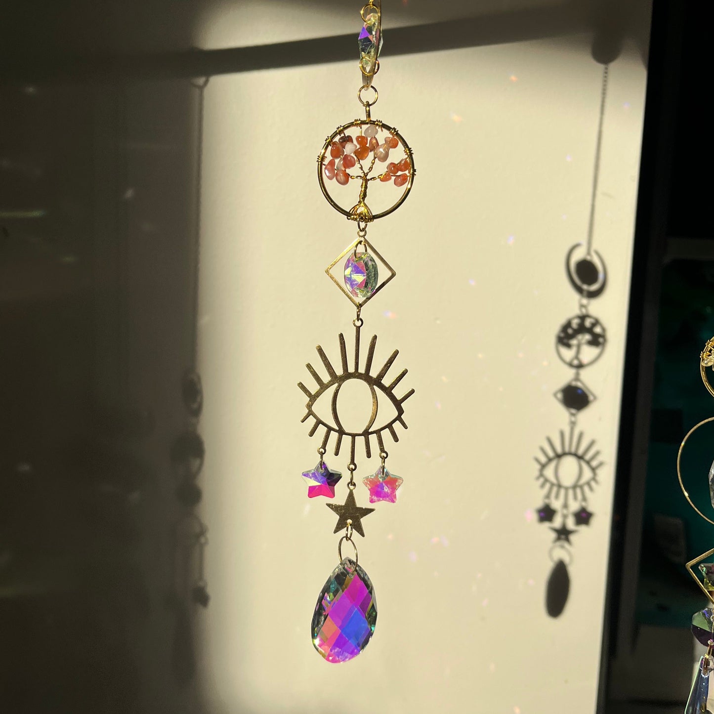 Decorative suncatcher with colorful crystals on a light background