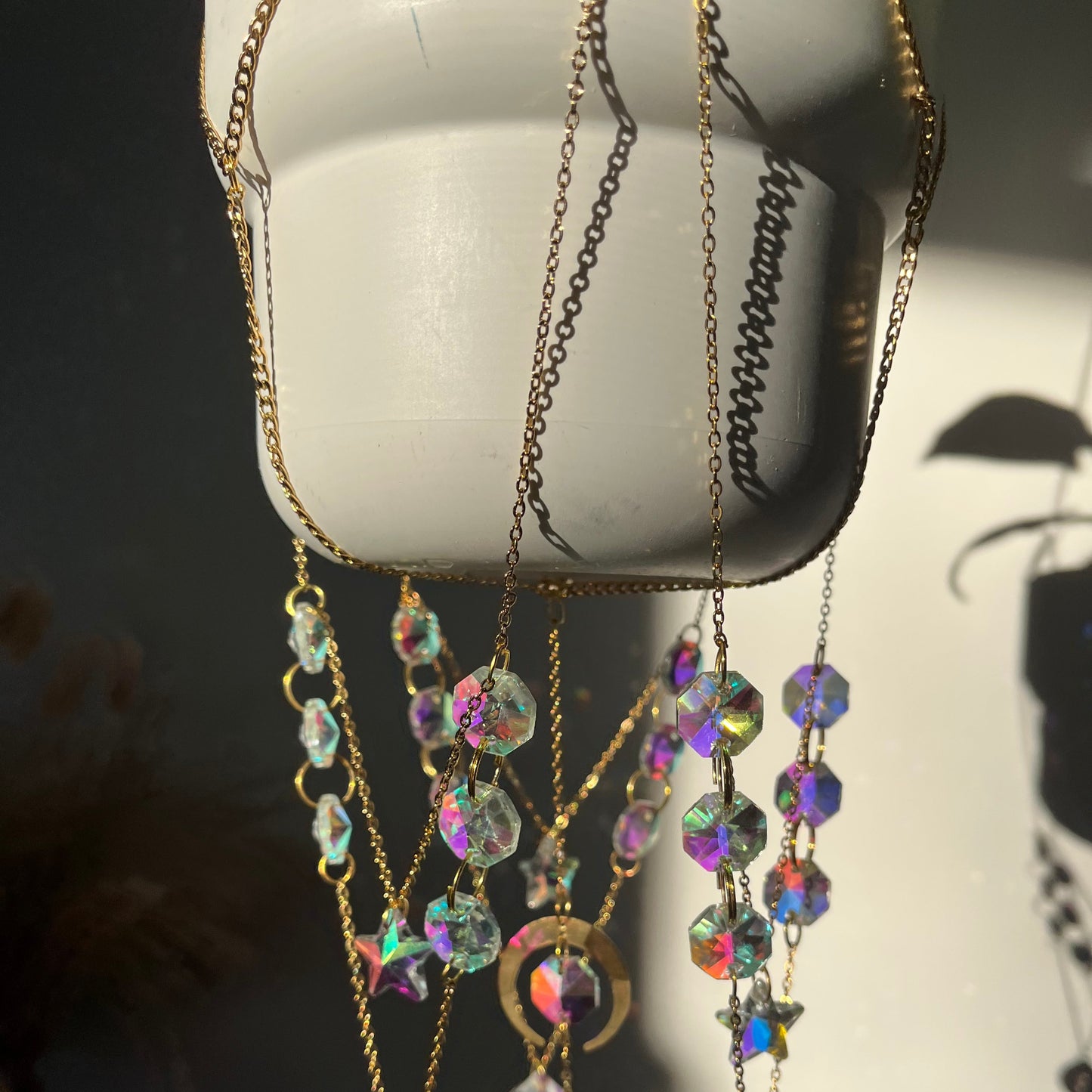 Chains with colorful beads on a white flower pot.