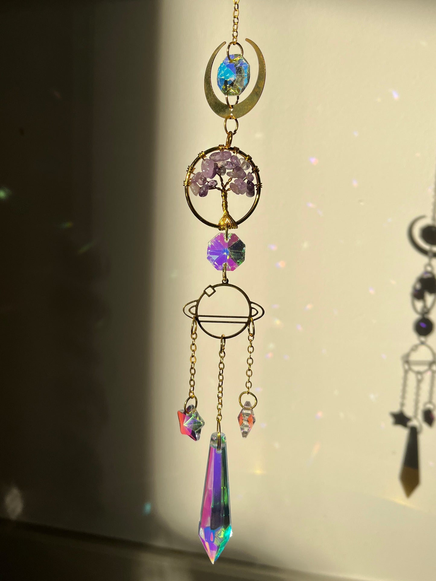 Decorative suncatcher with colorful crystals on a light background