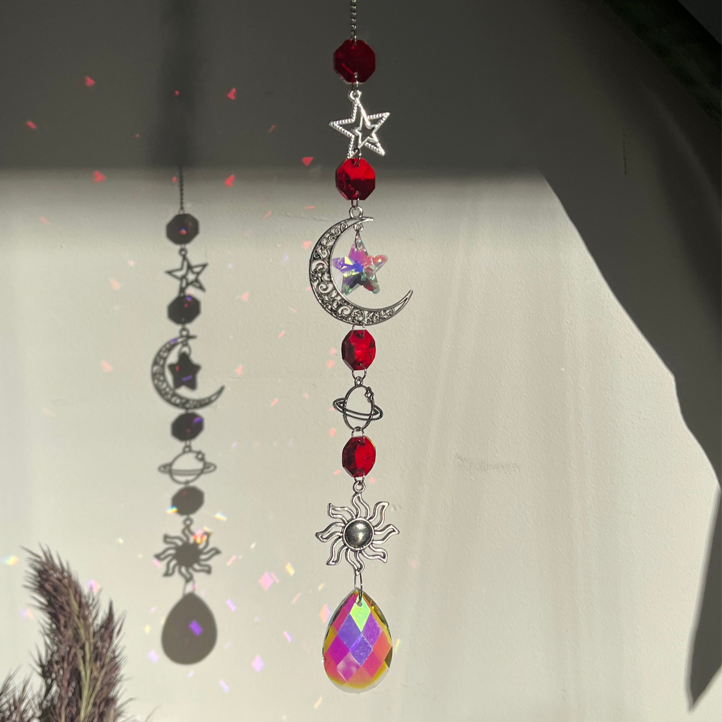 Decorative hanging ornament with celestial elements on a light background