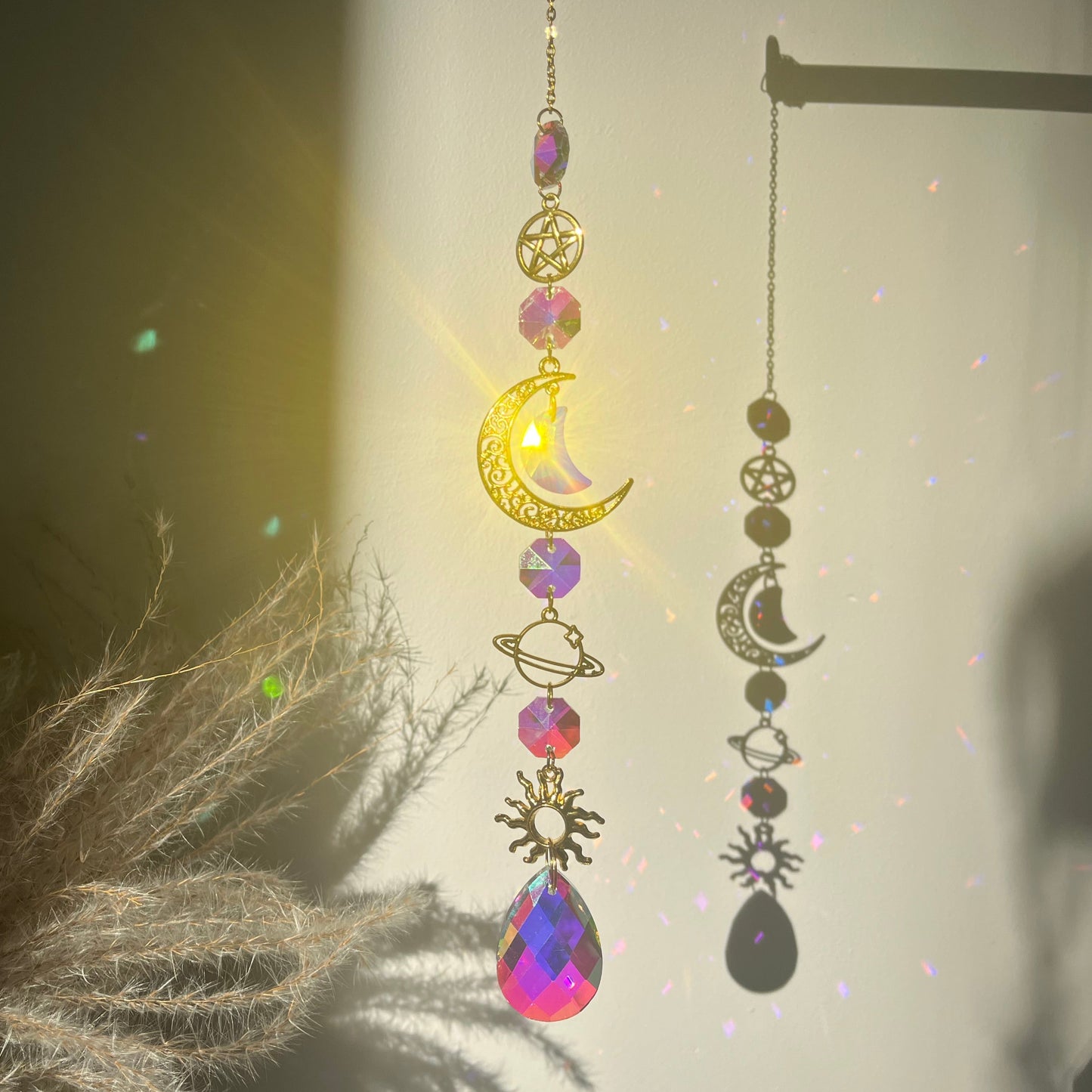 Decorative earrings with celestial designs on a neutral background