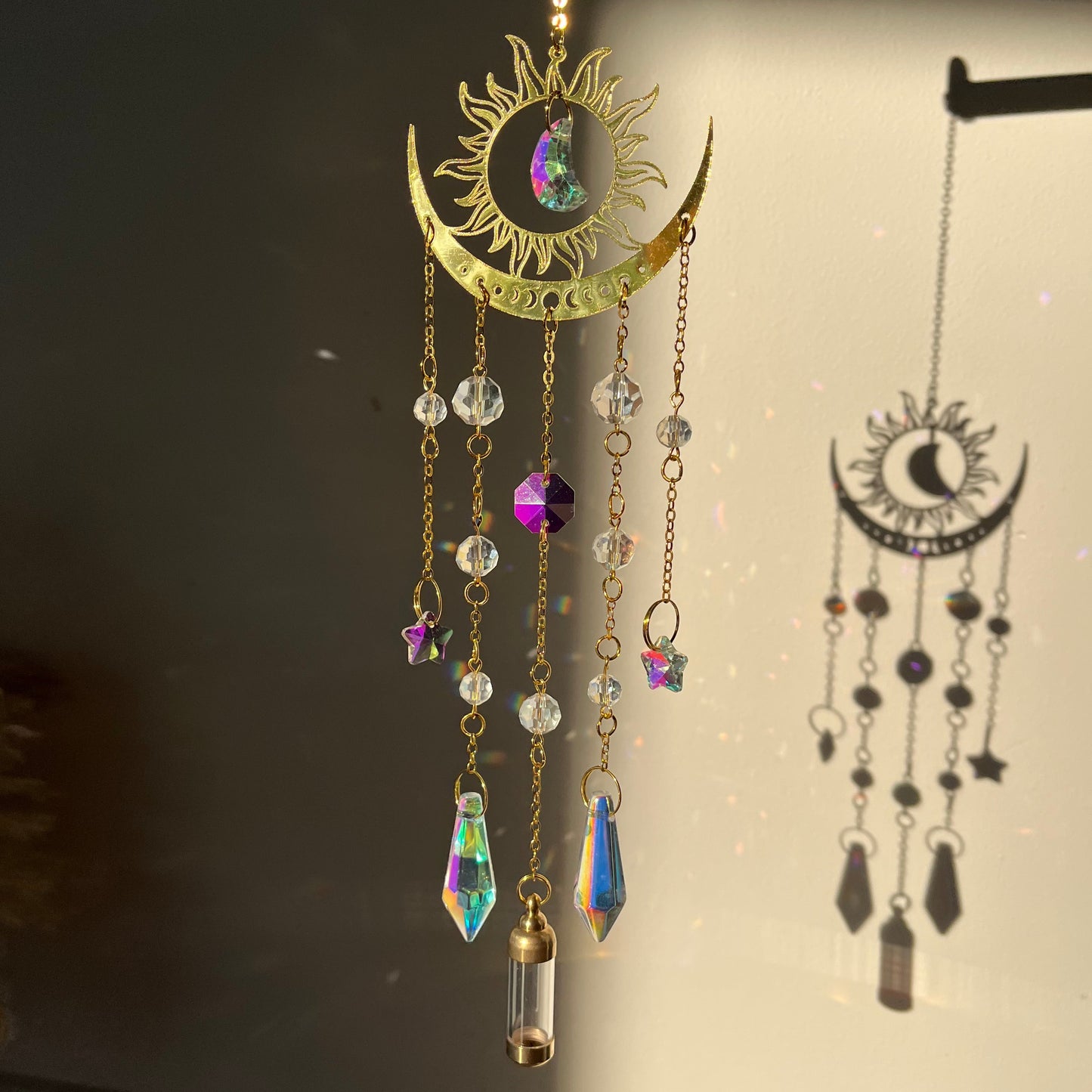 Decorative gold Suncatcher with gemstones on a dark background