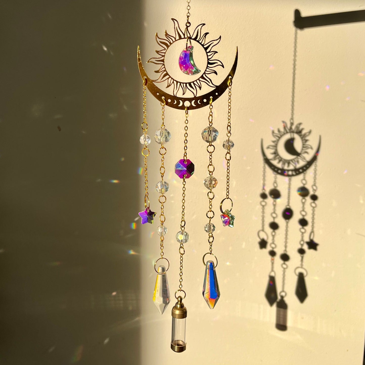 Decorative hanging ornament with crystals and beads on a plain background