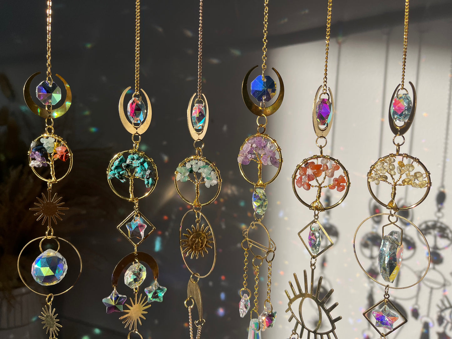 Decorative hanging ornaments with gemstones and gold accents on a blurred background