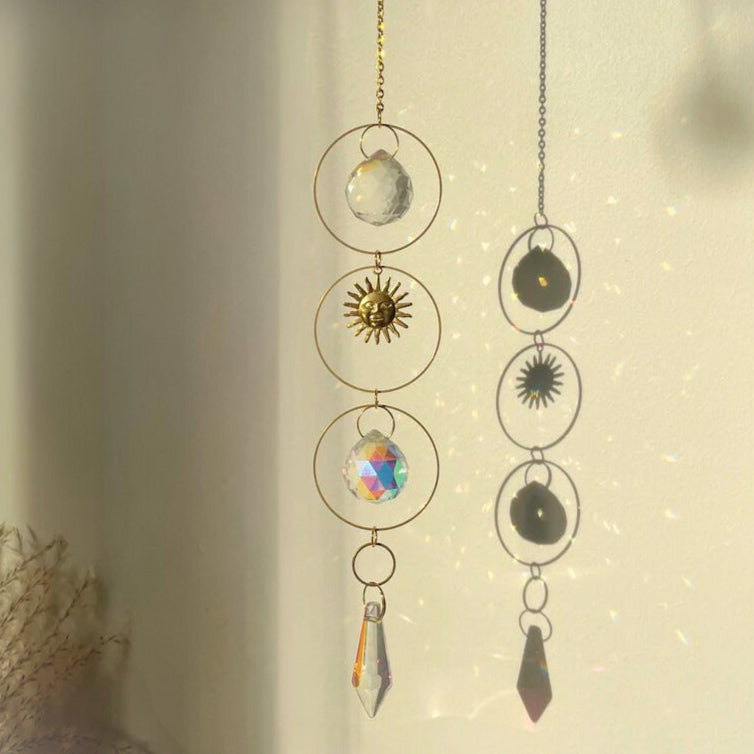 Decorative hanging with celestial-themed charms on a neutral background