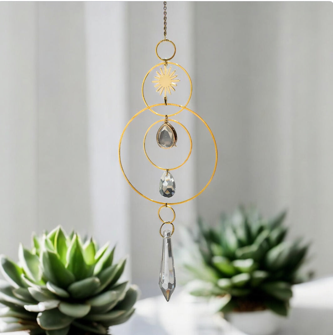 Decorative hanging crystal with succulents in the background