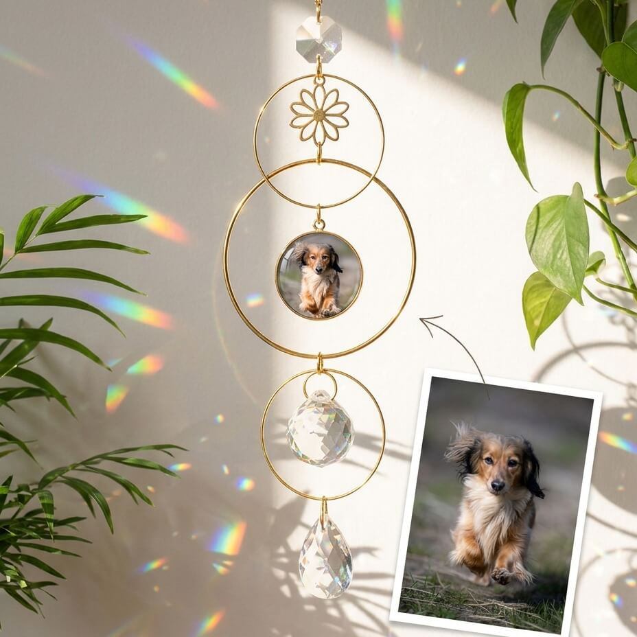Decorative hanging ornament with a photo of a dog, surrounded by green leaves.