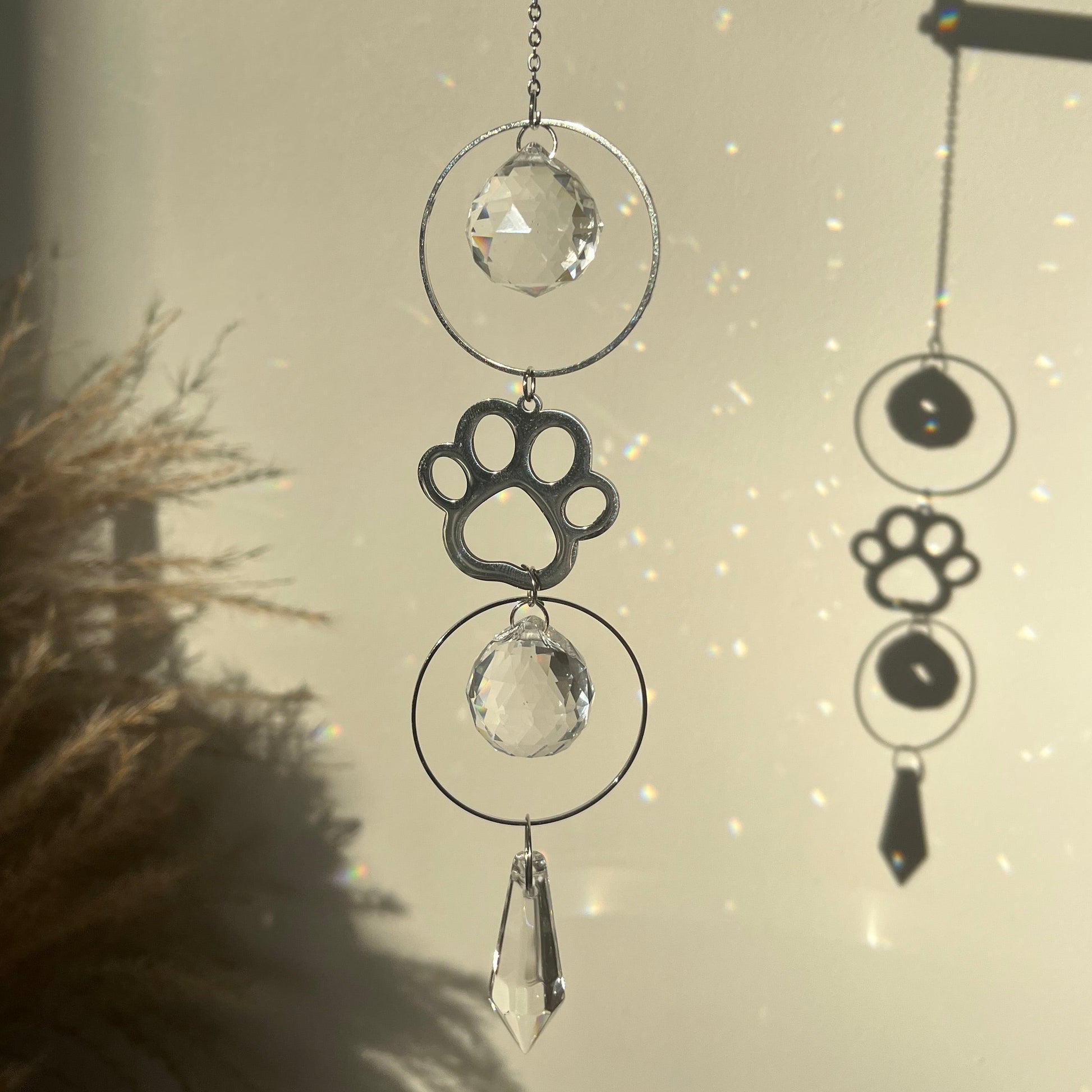 Decorative wall art with paw prints and crystals against a neutral background