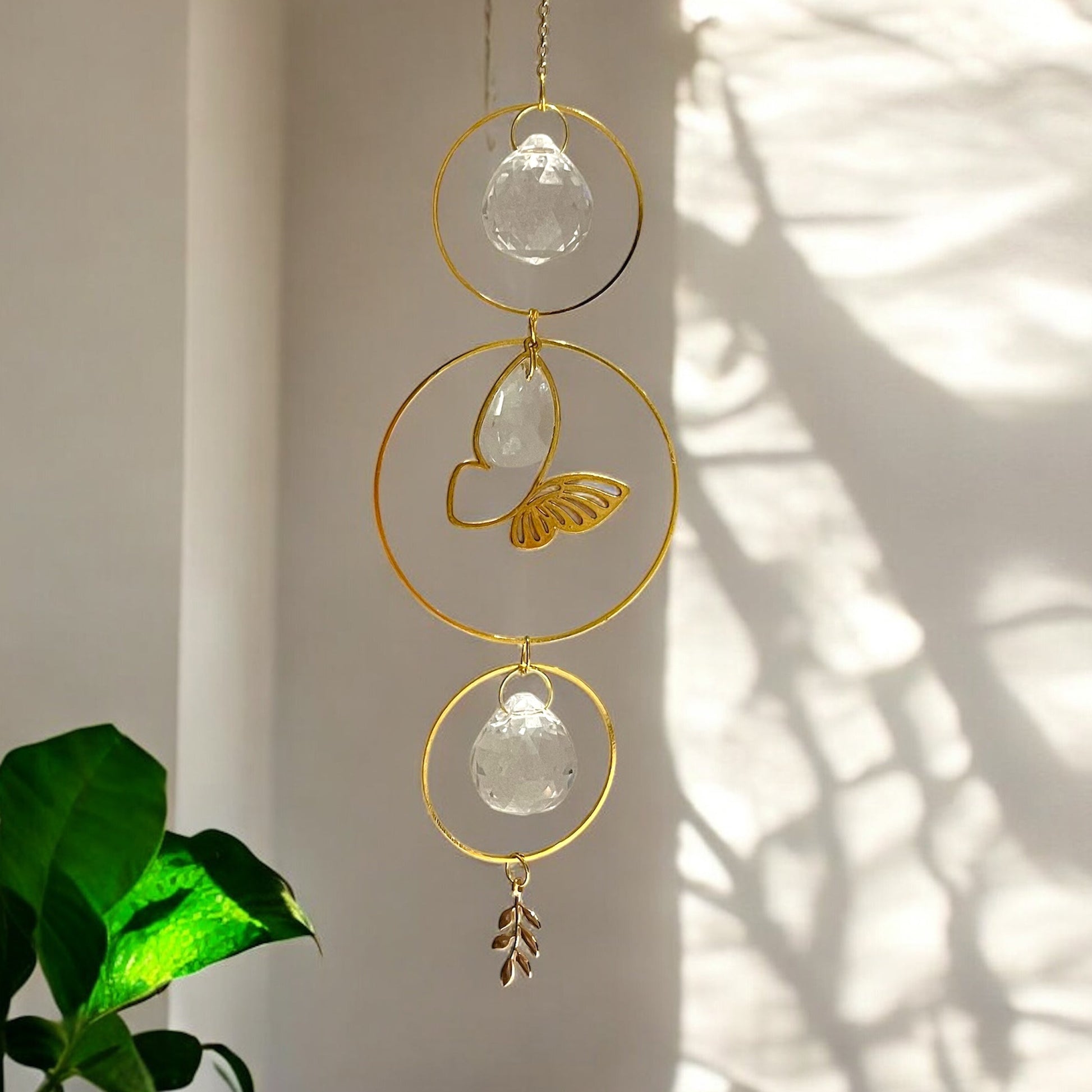 Decorative hanging crystal with gold accents on a neutral background