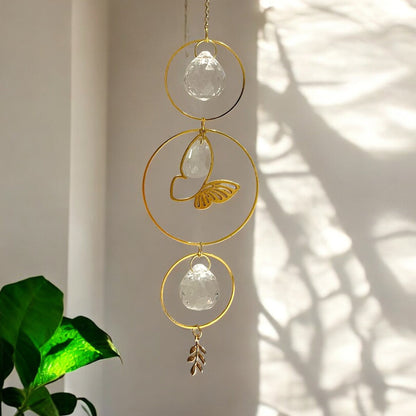 Decorative hanging crystal with gold accents on a neutral background