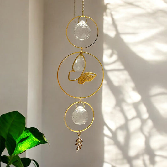 Decorative hanging crystal with gold accents on a neutral background