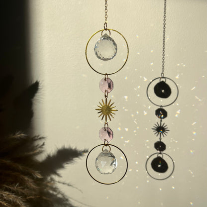 Decorative hanging with crystals and celestial elements on a neutral background