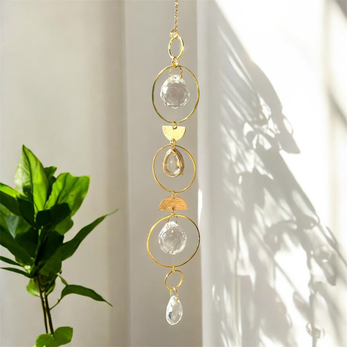 Decorative hanging crystal with gold accents on a light background