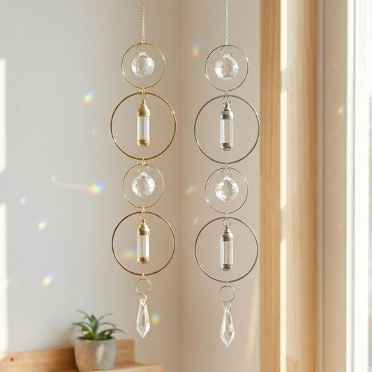 Decorative hanging crystal chimes with gold and silver elements in a bright room.