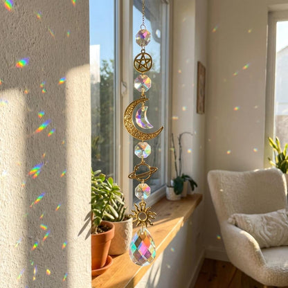 Decorative crystal hanging in a sunlit room with plants and a chair.