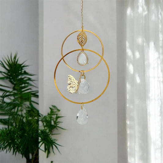 Suncatcher urn with a small ash holder and a butterfly design hanging in natural light.