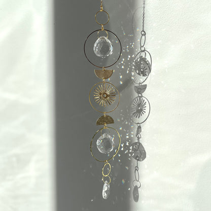 Decorative hanging with geometric shapes and crystals on a white background