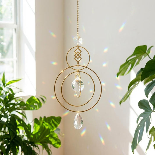Decorative hanging crystal with gold chain against a light background