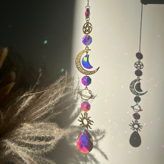Decorative necklace with celestial elements and gemstones on a dark background