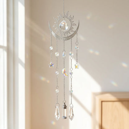 Decorative hanging crystal mobile with sun and moon design in a bright room.