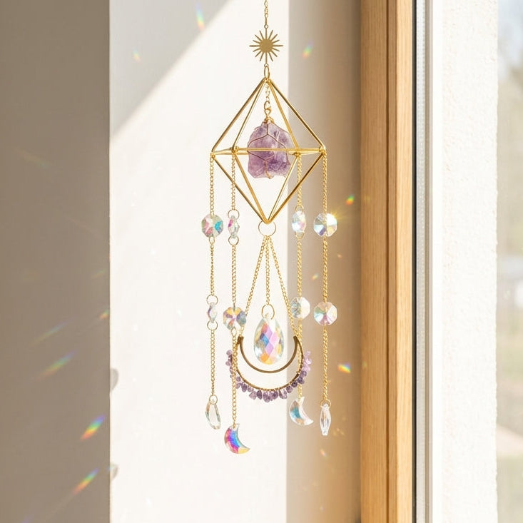 Decorative crystal hanging ornament on a windowsill with sunlight filtering through.
