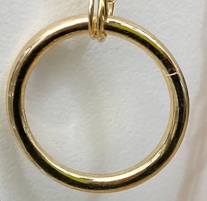 Gold ring pendant on a white background