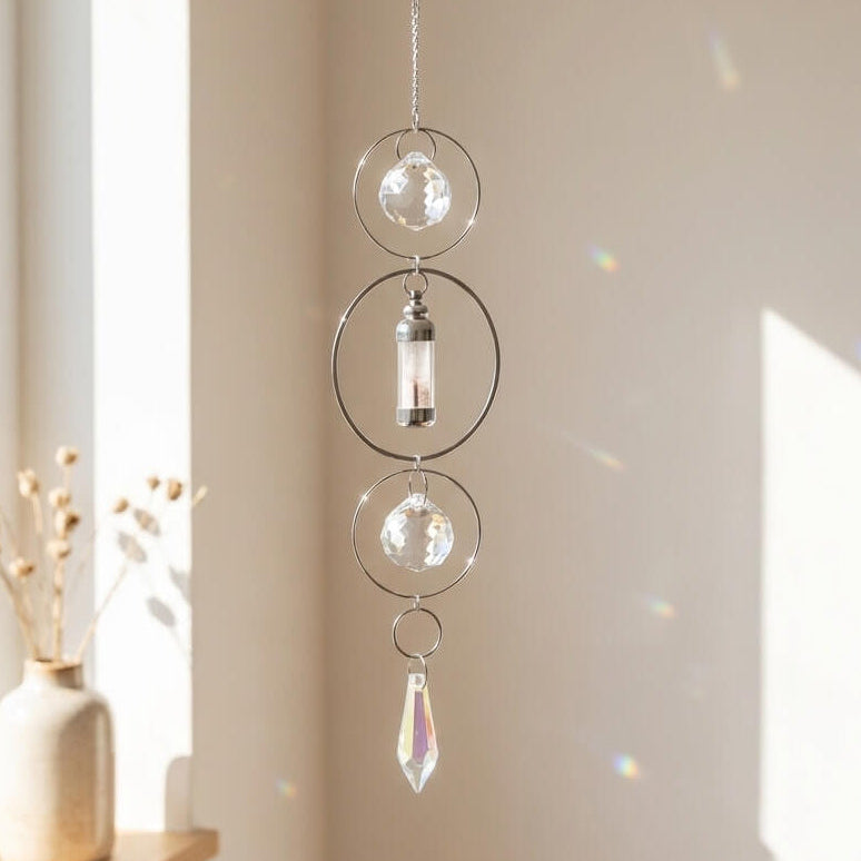 Decorative hanging crystal with a vase on a windowsill in a bright room