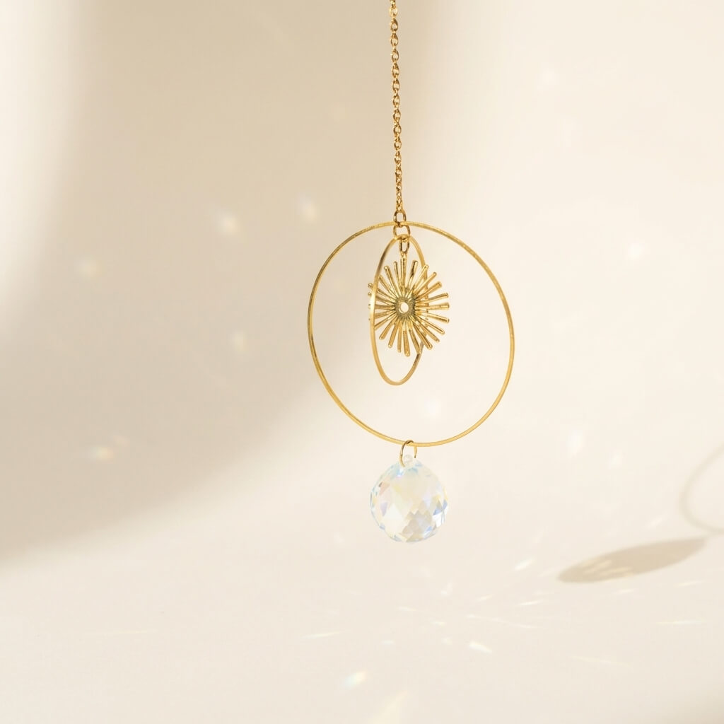 Gold necklace with a crystal pendant on a soft beige background
