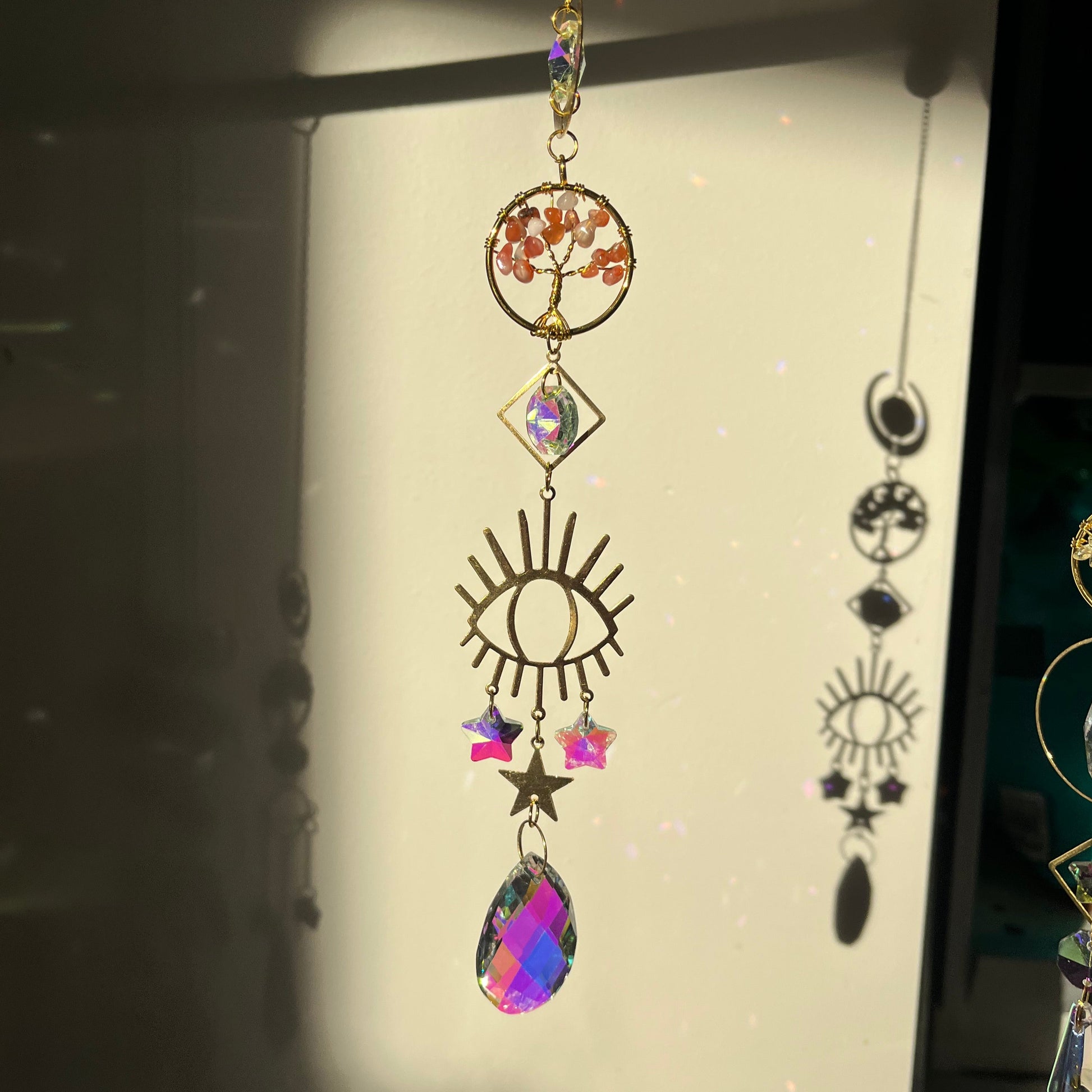 Decorative suncatcher with colorful crystals on a light background