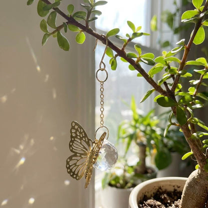 Butterfly-shaped decorative item hanging from a plant branch indoors