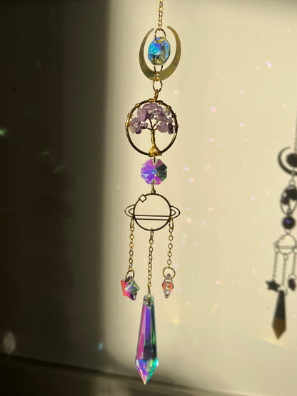 Decorative suncatcher with colorful crystals on a light background