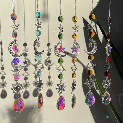 A series of decorative wind chimes with colorful gemstone pendants and silver elements, displayed against a light background.