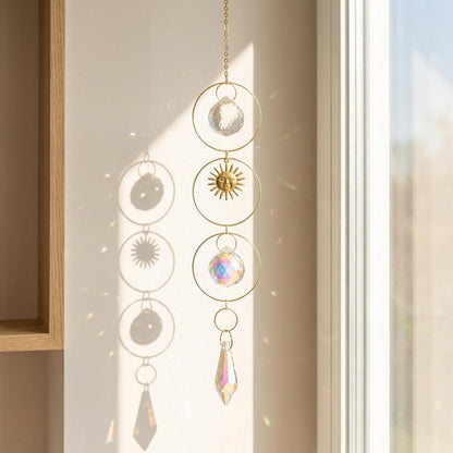 Decorative hanging crystal with sun and moon designs in a neutral setting