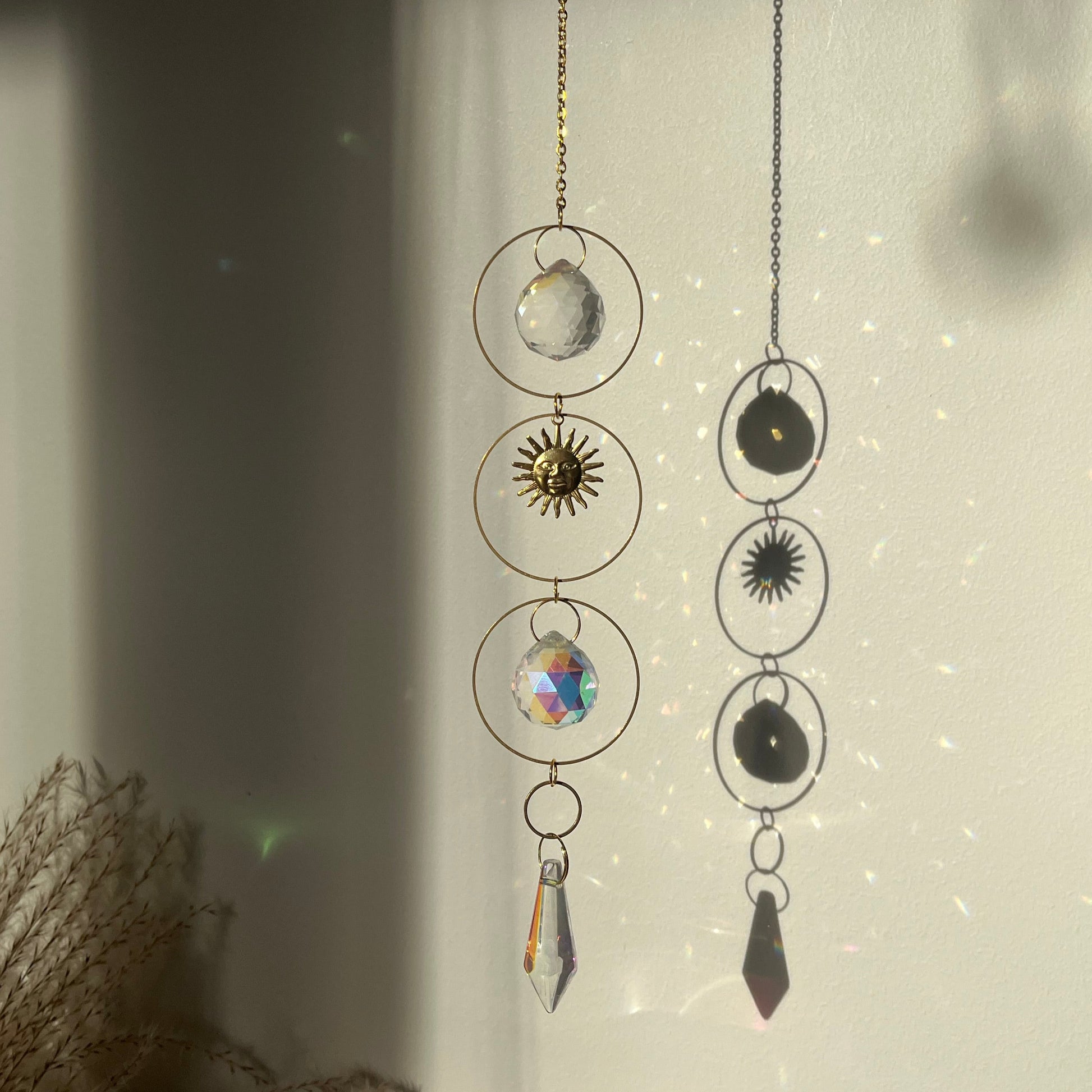 Decorative hanging mobile with circular designs and crystals on a light background