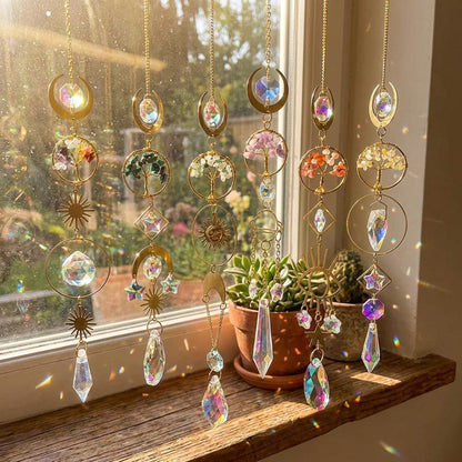 Decorative hanging crystal objects on a windowsill with sunlight filtering through.