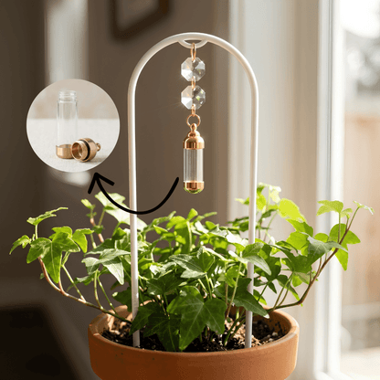 White metal plant stand with decorative elements next to a potted plant indoors.