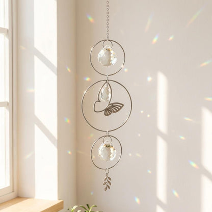 Decorative hanging crystal with butterfly design in a bright room