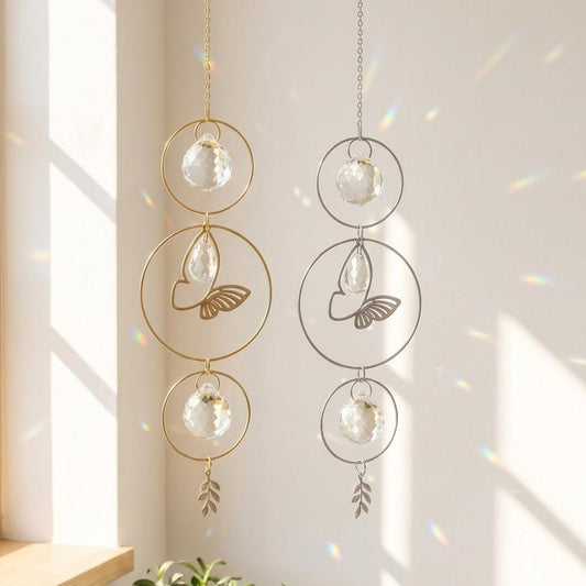 Decorative hanging ornaments with glass spheres and leaf designs on a light background.