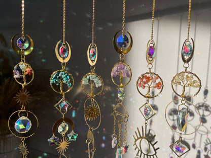 Decorative hanging ornaments with gemstones and gold accents on a blurred background
