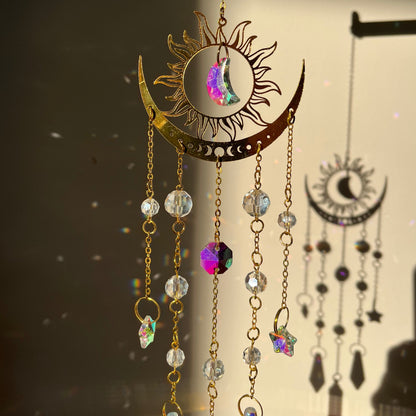 Suncatcher with sun and moon design and colorful beads on a dark background