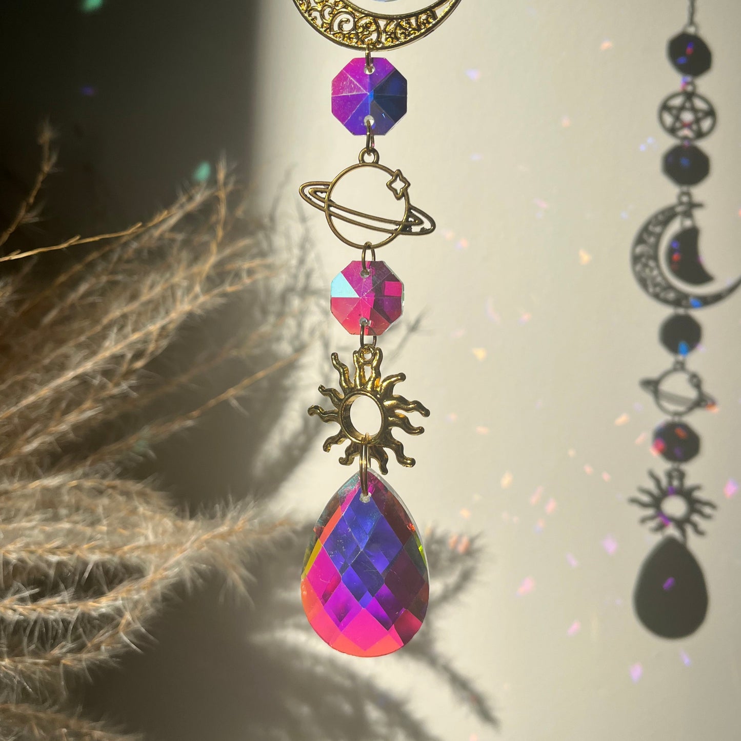 Decorative Suncatcher with celestial elements against a natural background