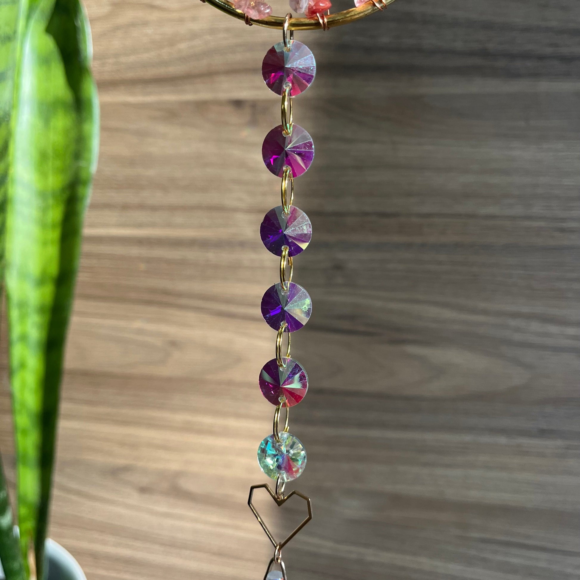 Decorative hanging with colorful beads on a wooden surface